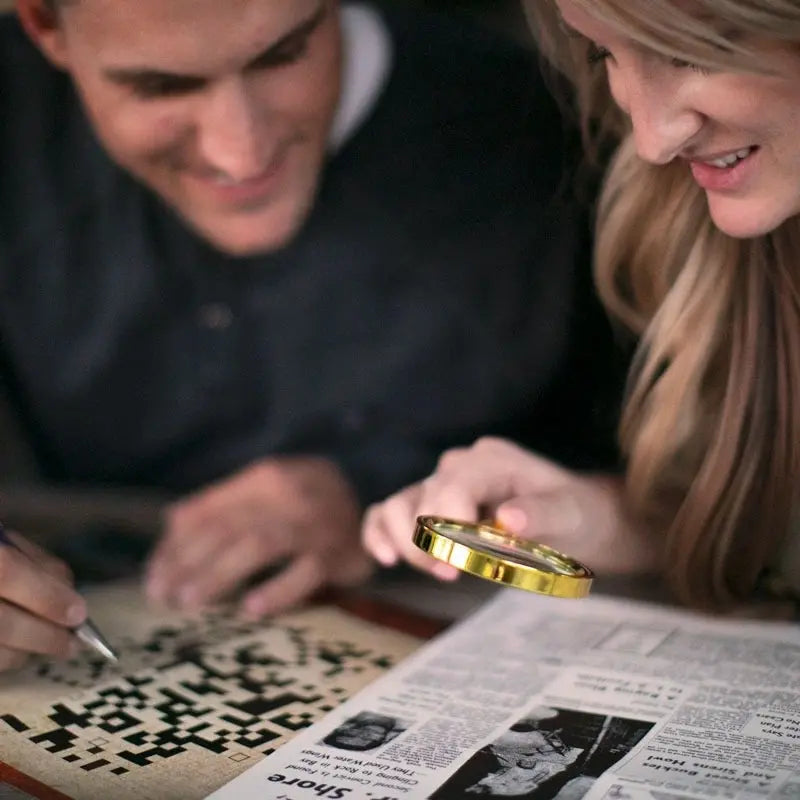 A couple looking for crossword clues with a magnifying glass