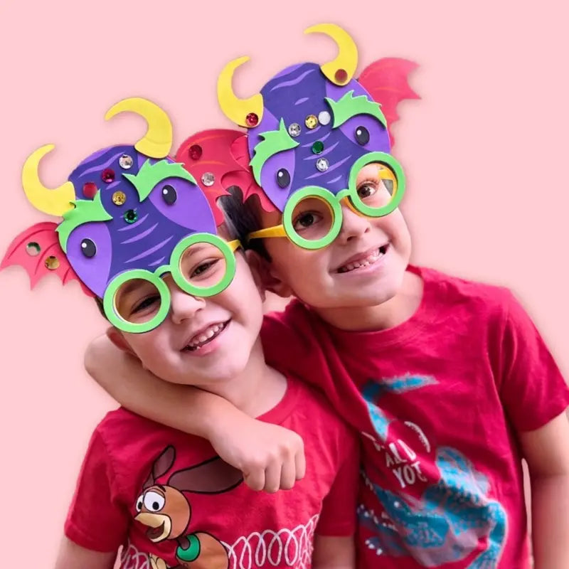 Two kids in red shirts with goofy green glasses.